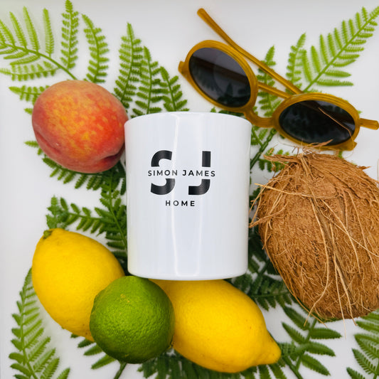 Flat lay of luxury summer candles from Simon James Home featuring citrus, fruity and fresh fragrance notes, ideal for brightening UK homes.