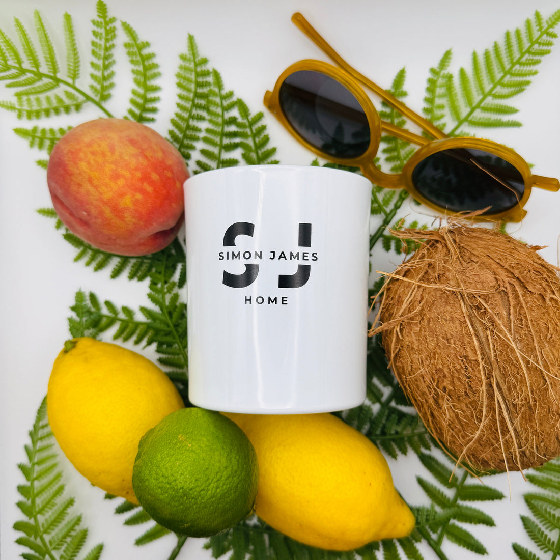 Flat lay of luxury summer candles from Simon James Home featuring citrus, fruity and fresh fragrance notes, ideal for brightening UK homes.